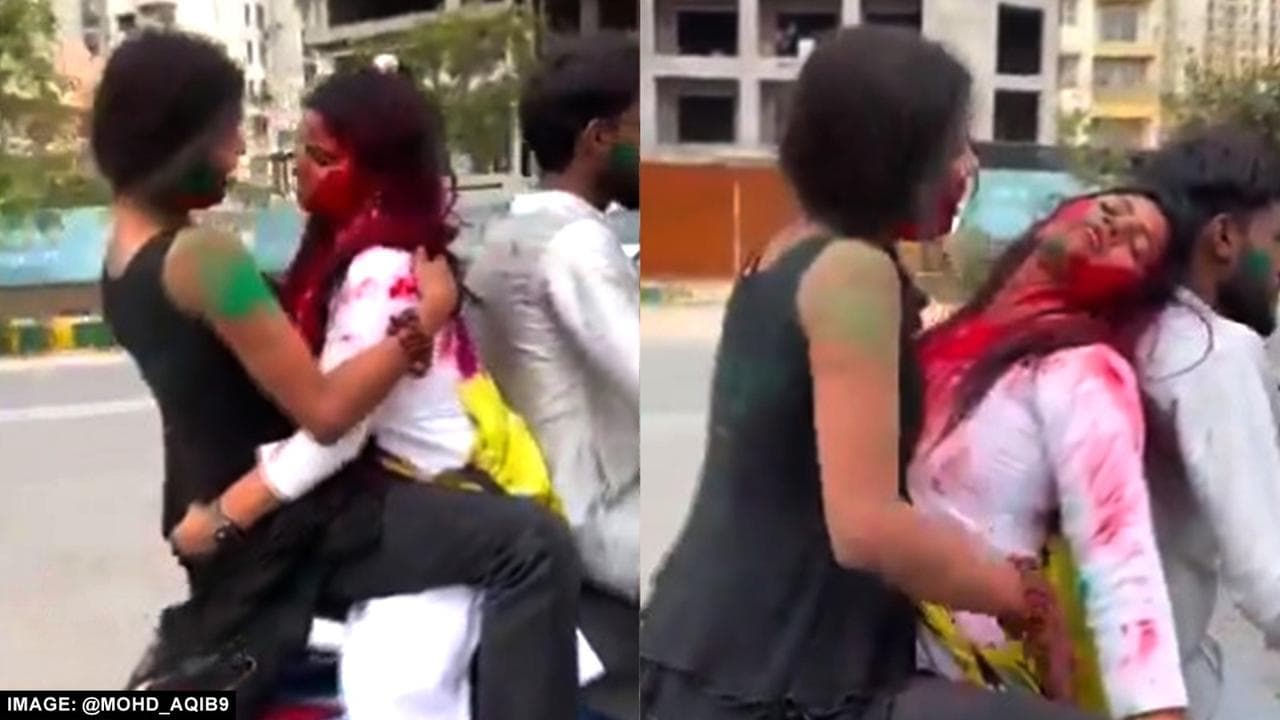 Two Girls Play Holi on moving scooty